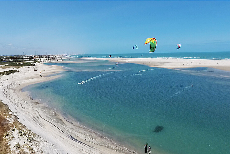 Parajuru kitesurfing beach aerial view - turquoise water, white sand beaches and colorful kites in tropical paradise
