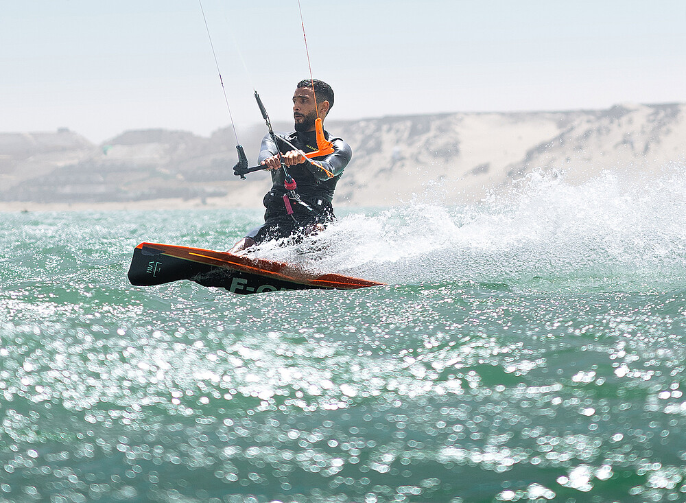 Kitesurfer NewSpiritDakhla kiteboarding in turquoise waters at Dakhla - Kiteboarding Club KBC New Spirit Dakhla Morocco