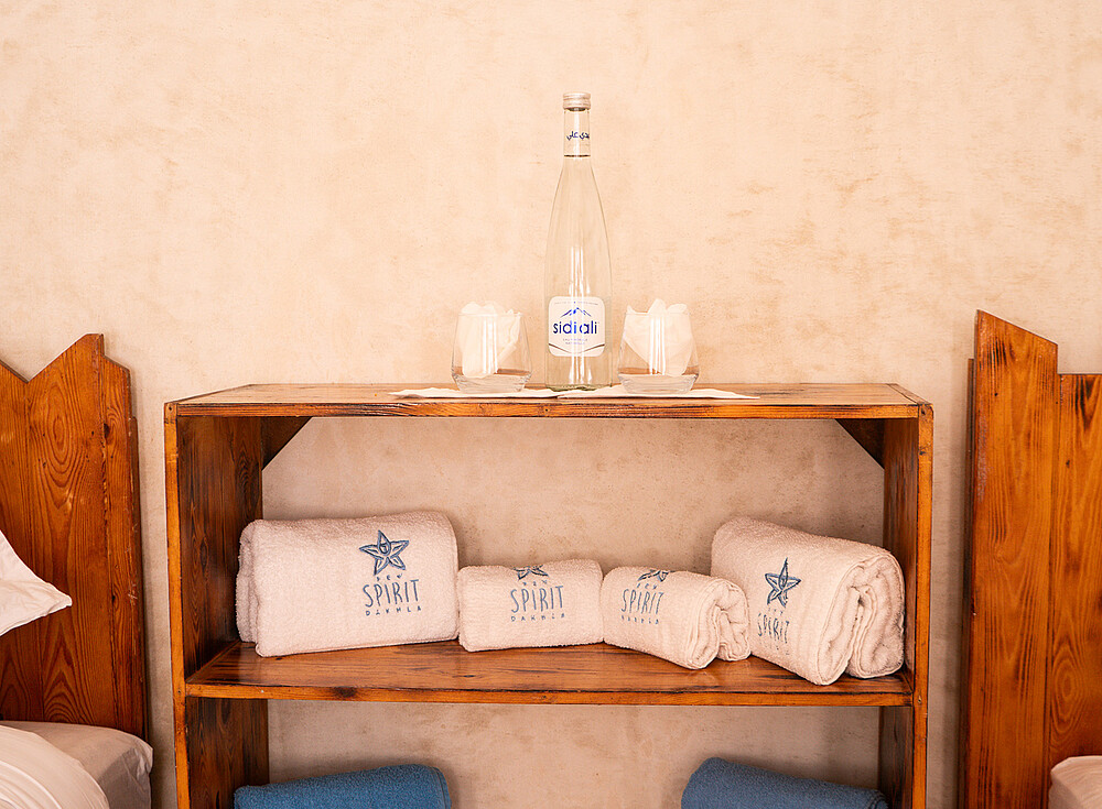 NewSpiritDakhla Standard Bungalow interior with towels and glassware for kiteboarding guests accommodation