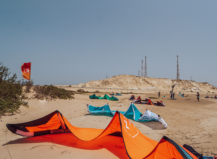 Kiteboarding kites and gear setup area at KBC New Spirit Kitesurf Center Dakhla beach in Morocco for water sports