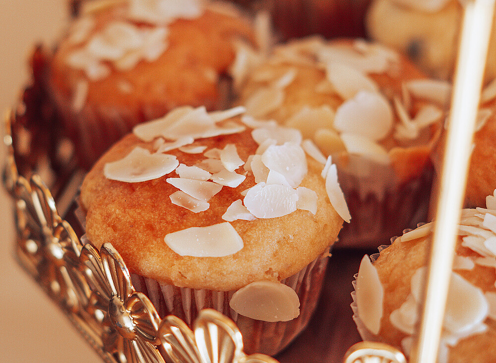 NewSpiritDakhla Breakfast - Fresh almond-topped muffins in basket, perfect fuel for kiteboarding adventures in Dakhla