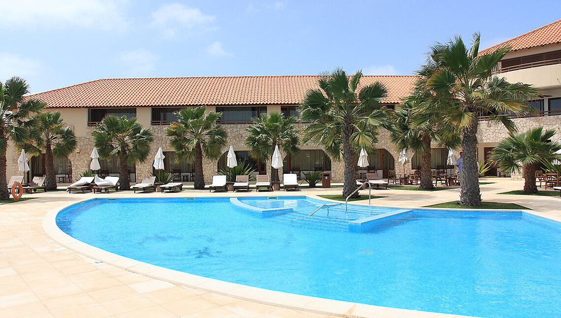 KBC Kitesurf Center Sal resort pool with palm trees and lounge area - kiteboarding vacation in Cape Verde