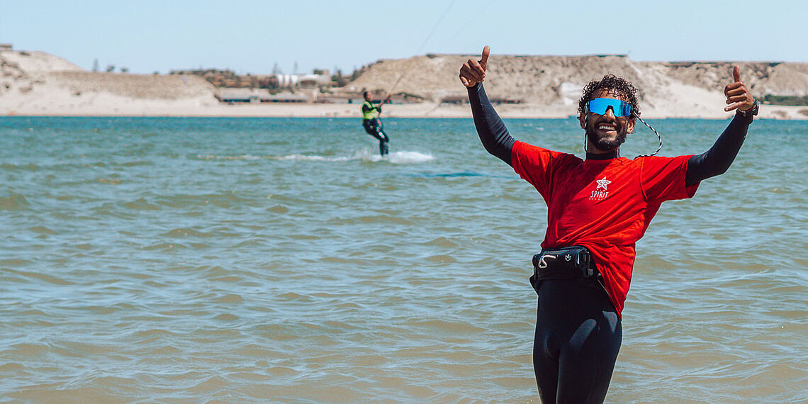 Kitesurfer NewSpiritDakhla LB celebrating on beach at Kiteboarding Club KBC New Spirit Dakhla, Morocco watersports