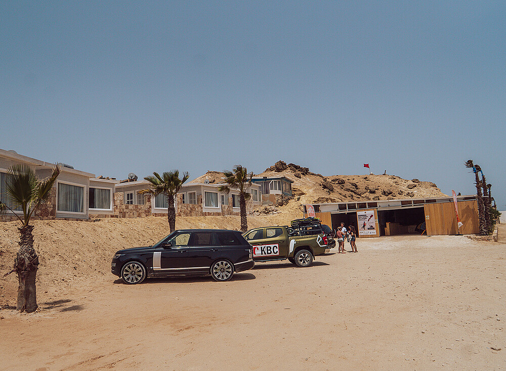 NewSpiritDakhla kitesurfing station with Range Rover and buildings at desert beach - kiteboarding travel destination