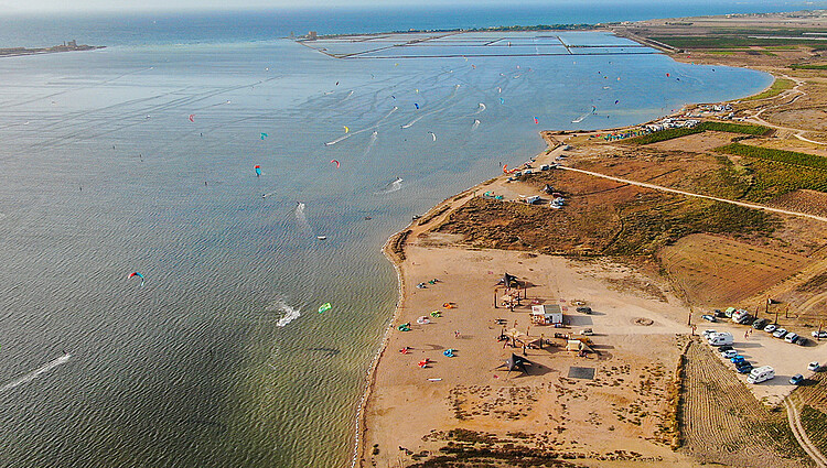 Lo Stagnone Sicily kiteboarding spot - aerial view of kite beach with many kitesurfers in shallow water