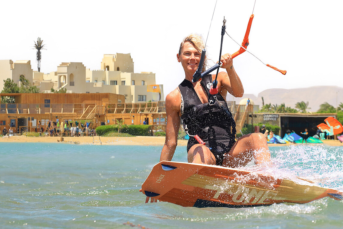 Female kitesurfer enjoying water sports at Kiteboarding Club KBC El Gouna beach, Red Sea Egypt