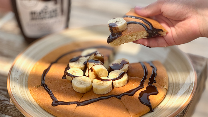Belly serveert banaan pannenkoeken met chocolade bij KBC Kitesurf Center El Gouna - perfect ontbijt na kitesurfen