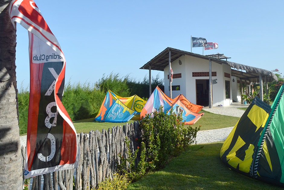 Kiteboarding equipment and colorful kites at Kiteboarding Club KBC Parajuru beach station in Ceará, Brazil