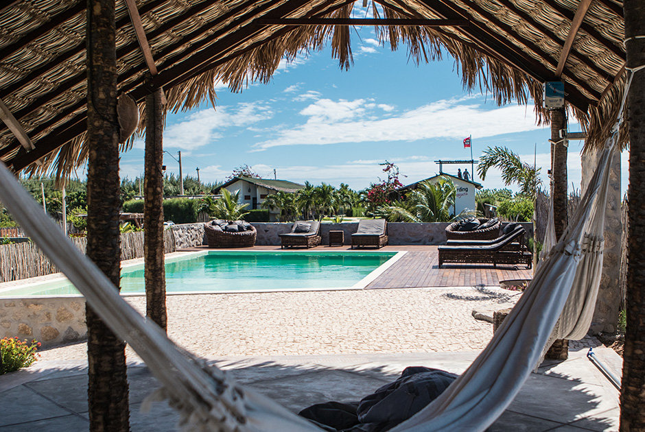 Relaxing hammock overlooking pool at Kiteboarding Club KBC Parajuru - tropical kitesurfing resort in Brazil