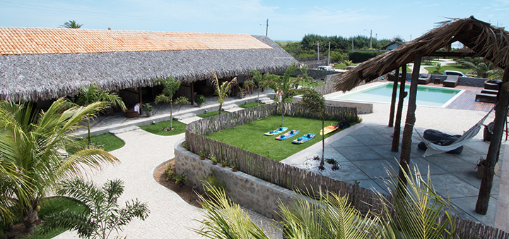 Kiteboarding Club KBC Parajuru resort with pool, palm trees and thatched roof buildings in Ceará Brazil