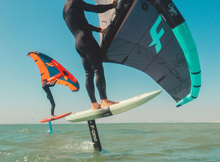 Kitefoiler riding above water at KBC Kitesurf Center Sizilien Lo Stagnone - hydrofoil kiteboarding action