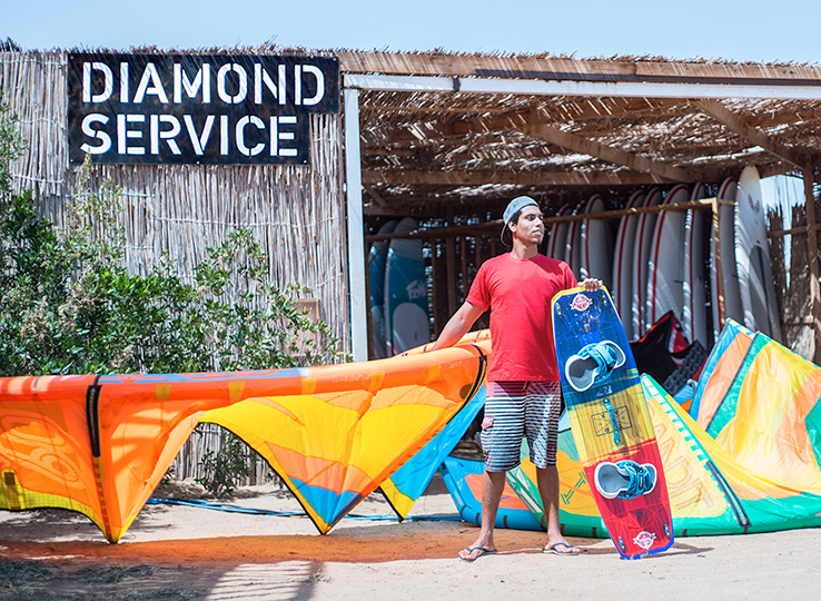 Kitesurfer with kites at Diamond Service Kitesurf Rental beach station - kiteboarding equipment rental and water sports