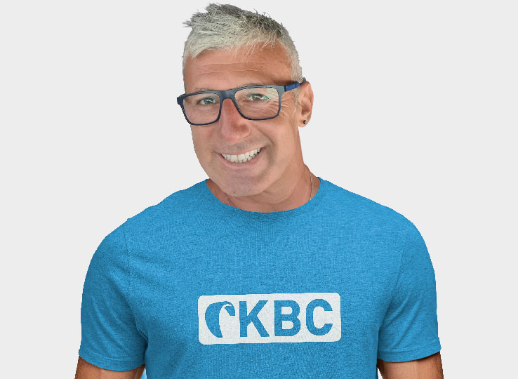 Salvatore from Sicily - kitesurfing instructor wearing CKBC shirt smiling, kiteboarding travel destination