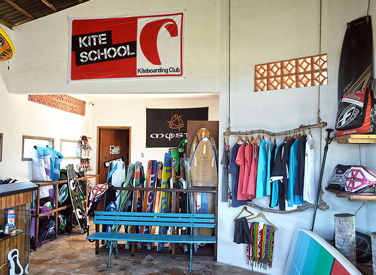 Kite school equipment rental shop with kiteboards, wetsuits and kitesurfing gear for beach water sports vacation