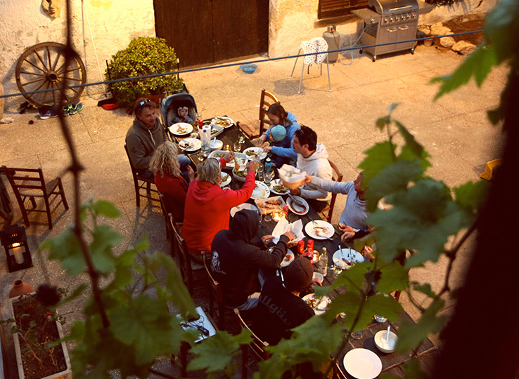 Kitesurfers enjoying Mediterranean meal at travel destination - perfect break between kiteboarding sessions