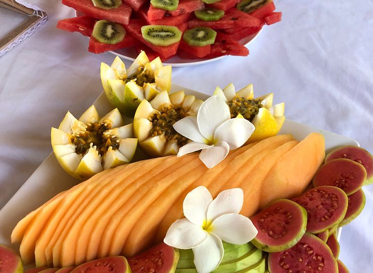 Tropical fruit platter with melon, papaya and kiwi - perfect post-kiteboarding snack at beach destination