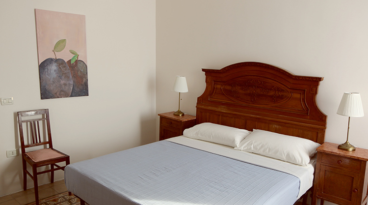 Maestro1 hotel room with wooden bed and nightstands - comfortable accommodation for kiteboarding travel